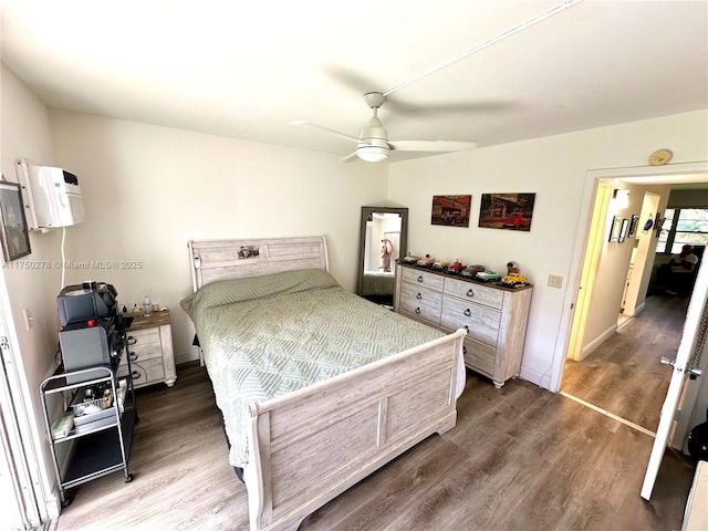 bedroom with dark wood-type flooring, ceiling fan, and baseboards