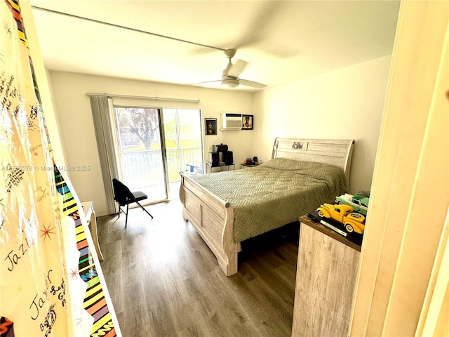 bedroom with access to outside, an AC wall unit, wood finished floors, and a ceiling fan