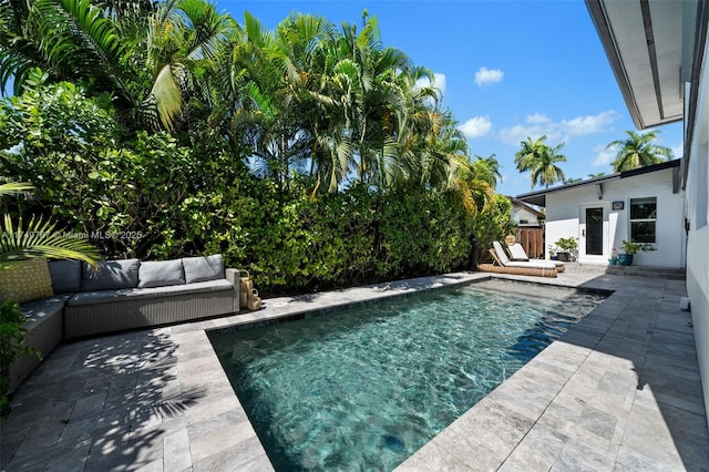 view of pool with a fenced in pool, a patio, outdoor lounge area, and fence