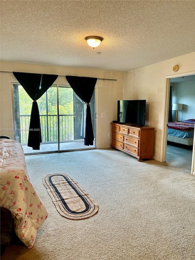 unfurnished bedroom with carpet floors, access to exterior, and a textured ceiling