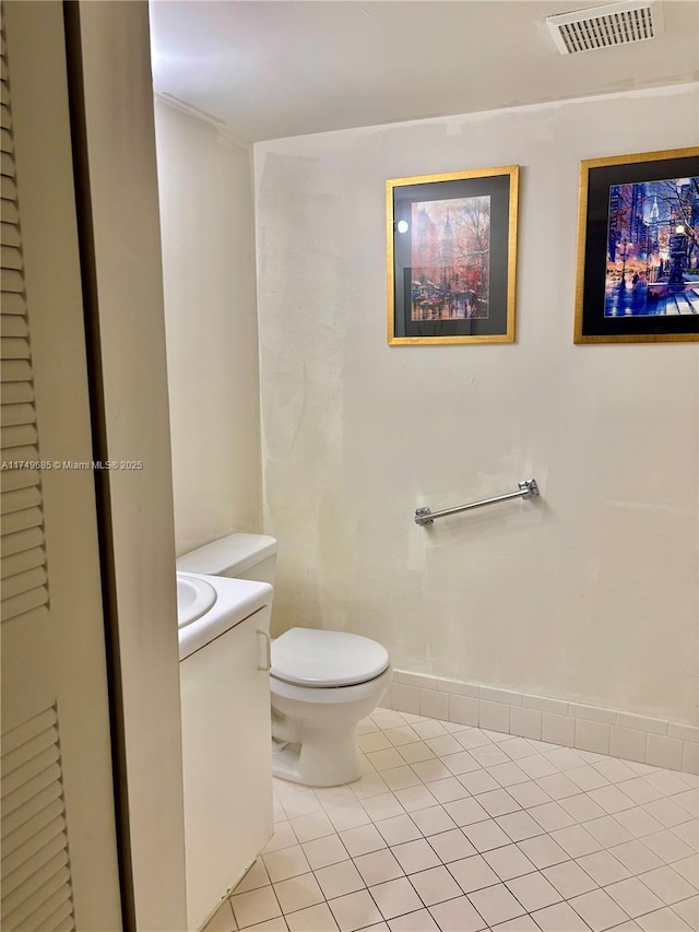 bathroom with tile patterned flooring, visible vents, vanity, and toilet