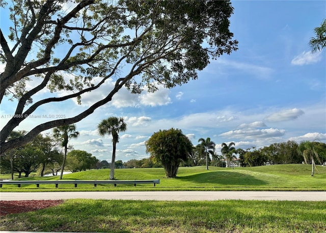 view of home's community featuring a lawn and golf course view