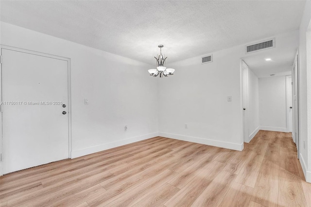 unfurnished room featuring light wood-style floors and visible vents