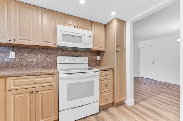 kitchen featuring white appliances, tasteful backsplash, light wood-style flooring, light countertops, and light brown cabinets