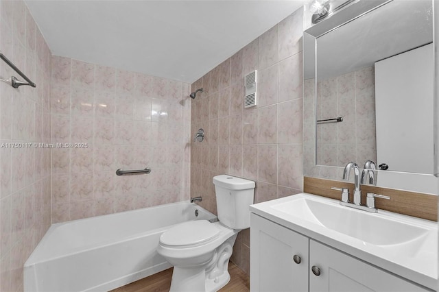 full bathroom featuring visible vents, toilet, shower / bathtub combination, vanity, and tile walls