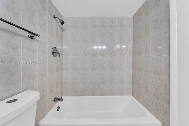 bathroom featuring shower / bath combination and toilet