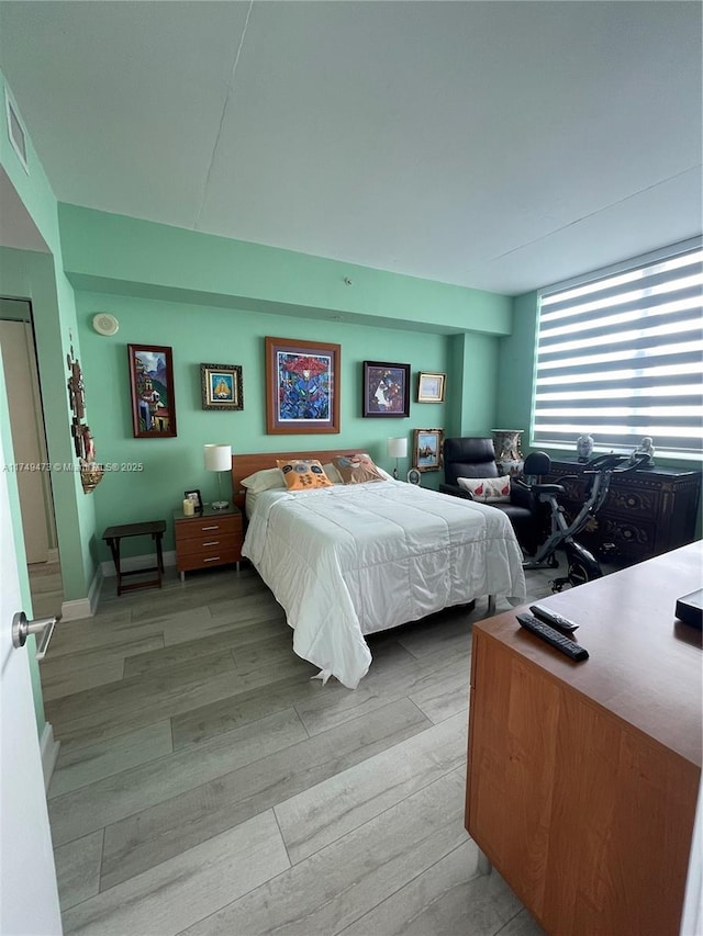 bedroom featuring light wood-style floors