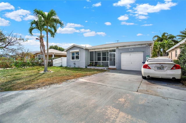 view of front of home with an attached garage, a front lawn, concrete driveway, and stucco siding