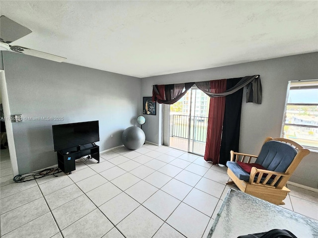 sitting room featuring baseboards and light tile patterned flooring