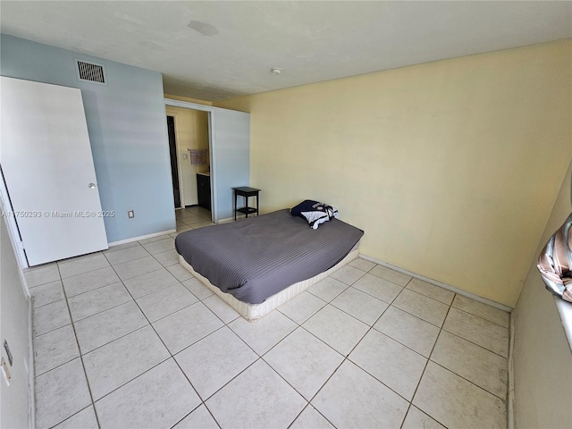 unfurnished bedroom featuring visible vents and light tile patterned flooring