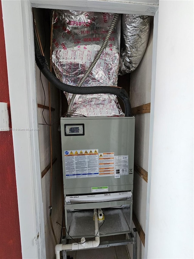 utility room featuring heating unit