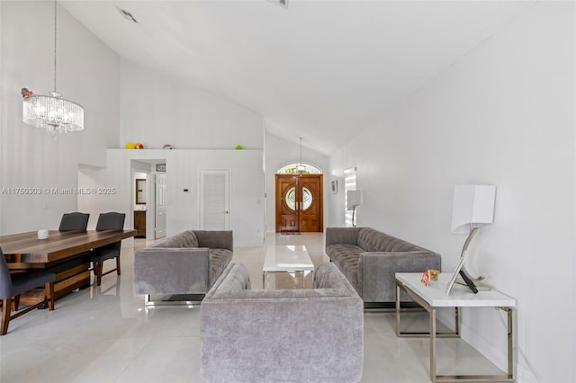 living room with baseboards and high vaulted ceiling