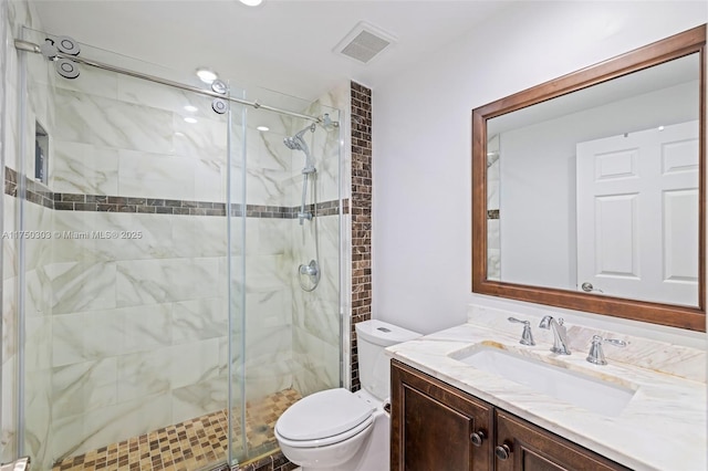 full bathroom with toilet, a stall shower, vanity, and visible vents