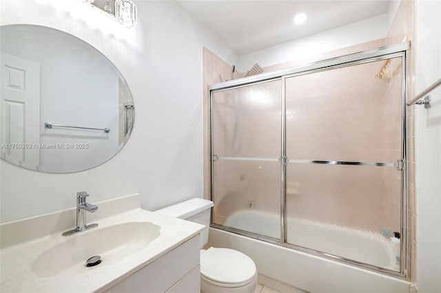 full bathroom featuring enclosed tub / shower combo, vanity, and toilet