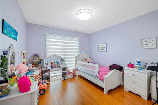 bedroom featuring light wood-style floors