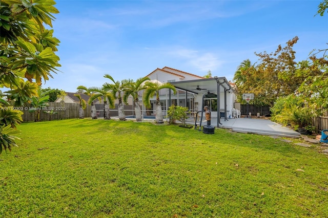 view of yard featuring a ceiling fan, a fenced backyard, and a patio