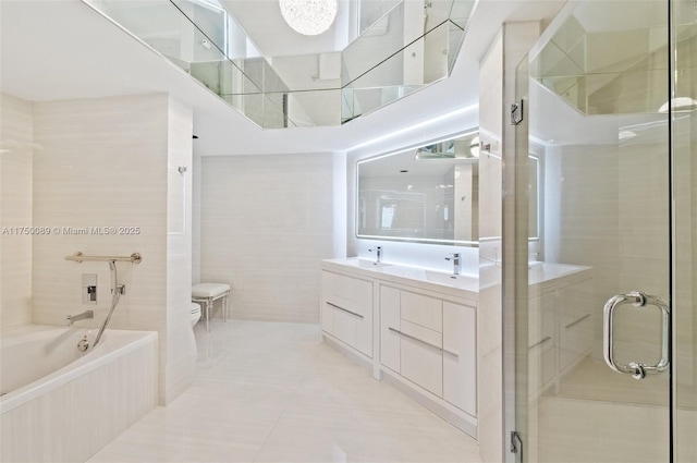 full bath featuring a stall shower, toilet, a bath, tile patterned floors, and tile walls