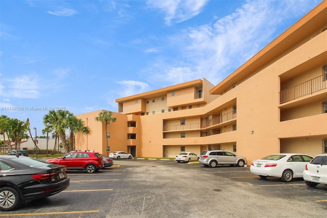 view of property featuring uncovered parking