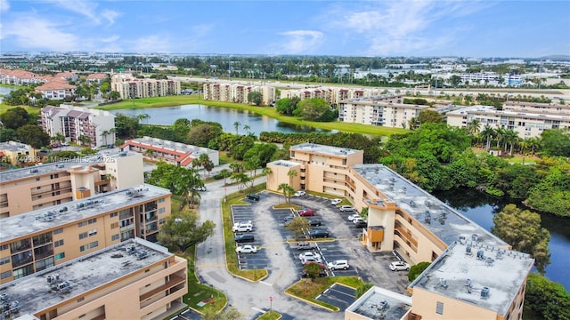 birds eye view of property featuring a water view and a city view