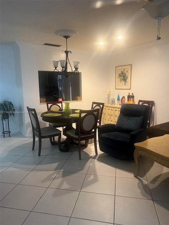 tiled dining room with visible vents and an inviting chandelier