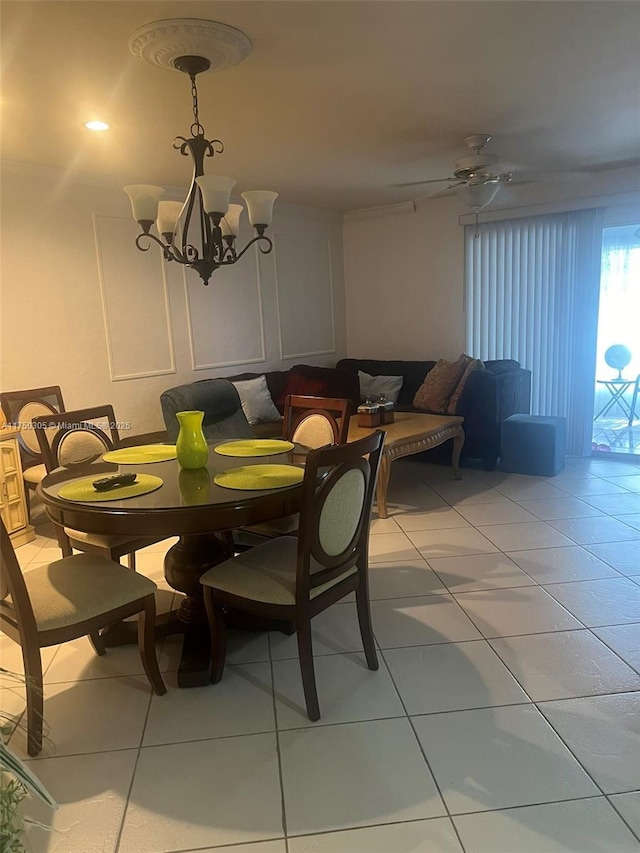 dining room featuring light tile patterned floors and ceiling fan with notable chandelier