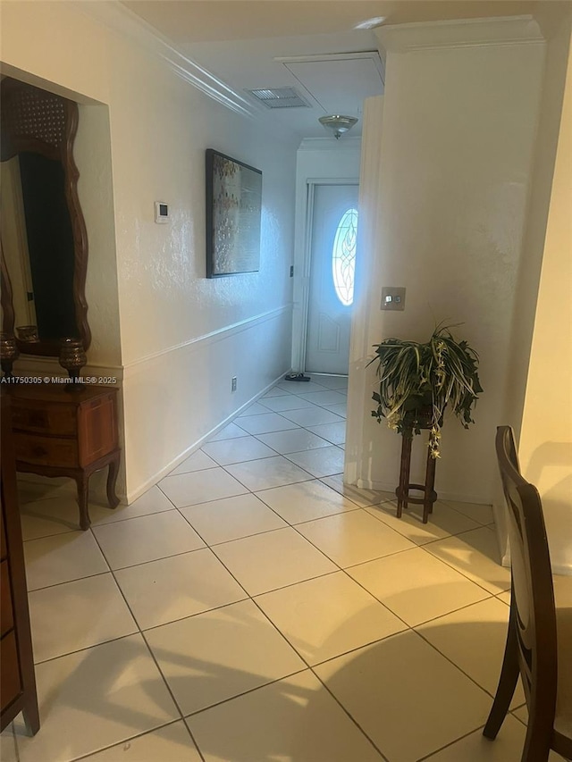 hall with crown molding and light tile patterned floors