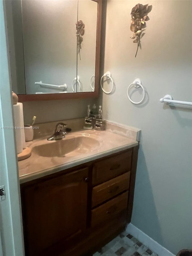 bathroom featuring baseboards and vanity