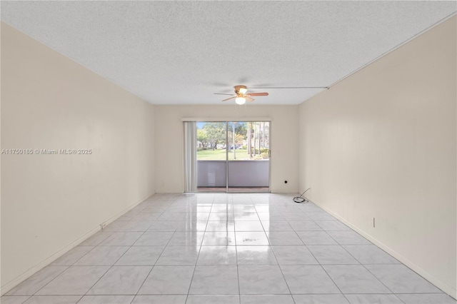 empty room with baseboards, a ceiling fan, a textured ceiling, and light tile patterned flooring