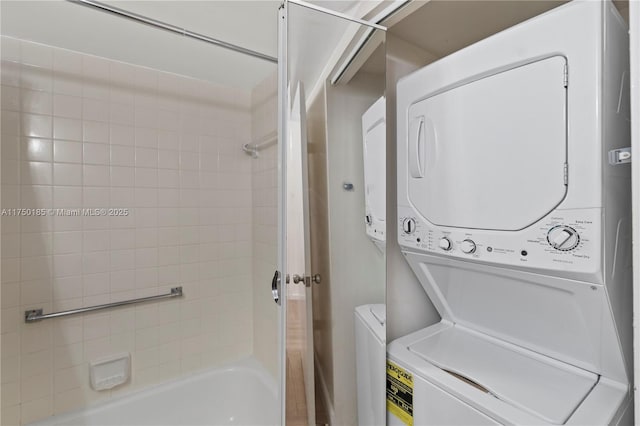 laundry room featuring laundry area and stacked washer / drying machine