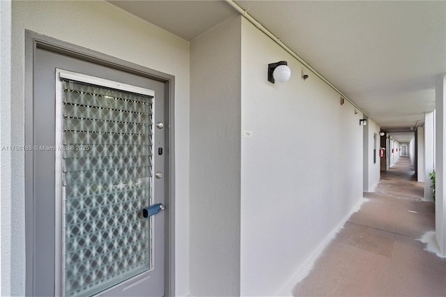 entrance to property featuring stucco siding