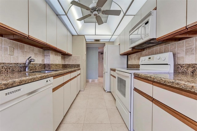 kitchen featuring white appliances and white cabinetry