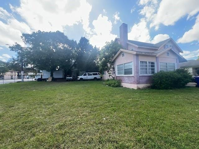 view of home's exterior featuring a lawn