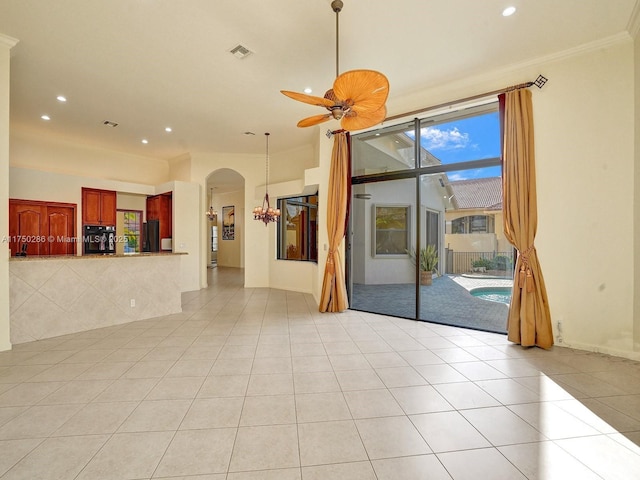 unfurnished living room featuring visible vents, arched walkways, a ceiling fan, light tile patterned flooring, and recessed lighting