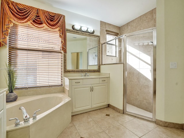 full bathroom with a garden tub, tile patterned flooring, vanity, baseboards, and a shower stall