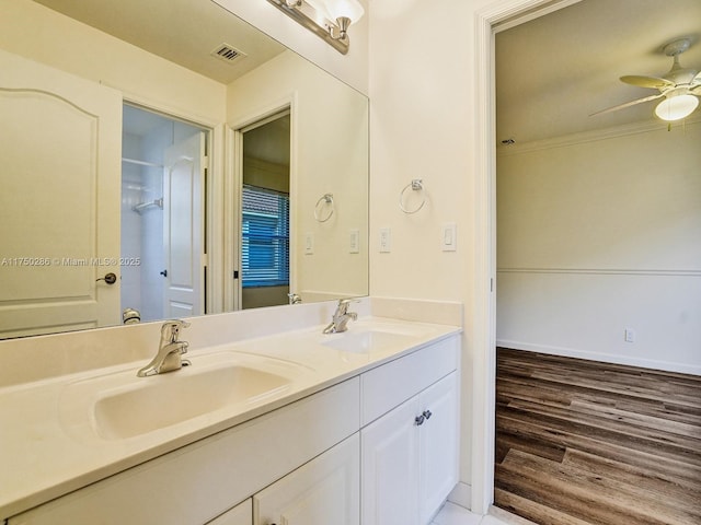 bathroom featuring double vanity, ceiling fan, visible vents, and a sink