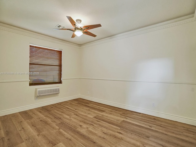 unfurnished room with a wall mounted AC, wood finished floors, a ceiling fan, and crown molding