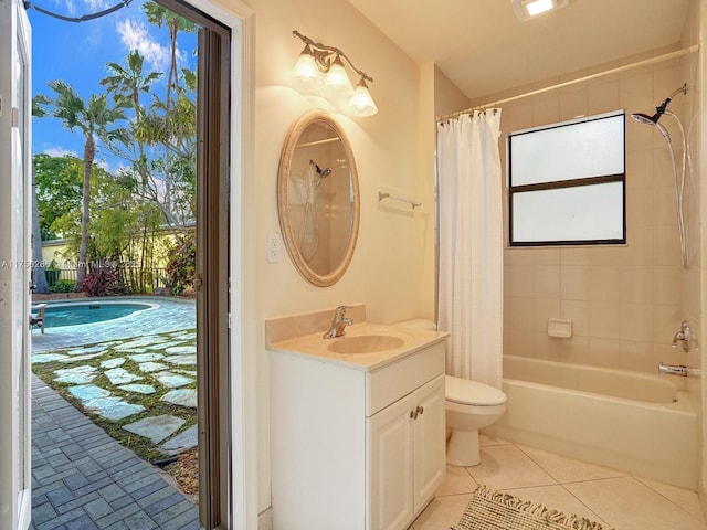 full bath featuring toilet, tile patterned flooring, vanity, and shower / tub combo with curtain