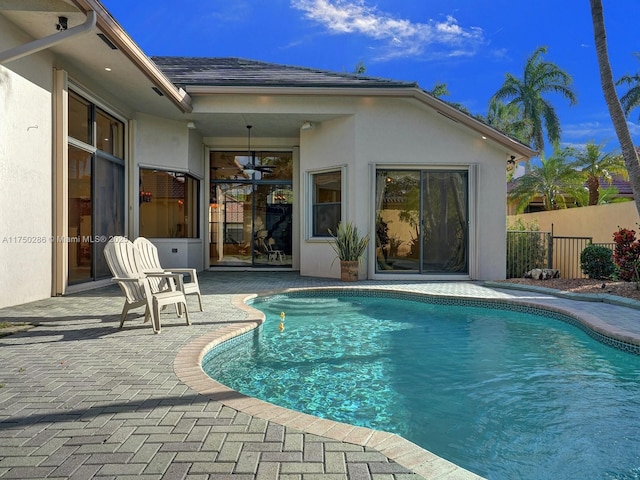 view of swimming pool featuring a patio area, fence, and a fenced in pool