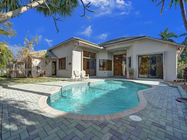 pool with ceiling fan and a patio