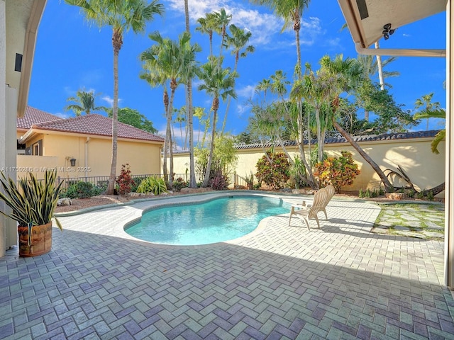 view of pool with a fenced backyard, a fenced in pool, and a patio