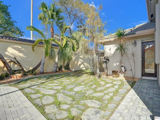 view of yard featuring fence and a patio