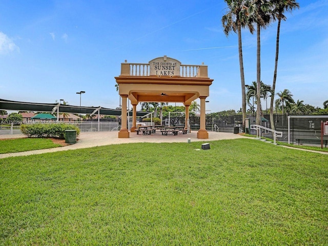 view of home's community featuring fence and a lawn