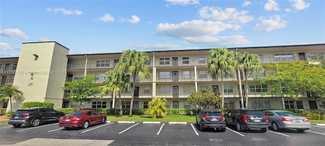 view of building exterior with uncovered parking