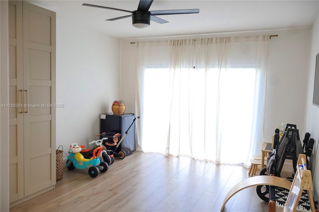 interior space featuring ceiling fan, light wood-type flooring, and a wealth of natural light