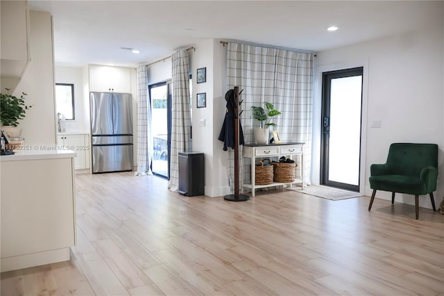 interior space with light wood-style flooring and recessed lighting