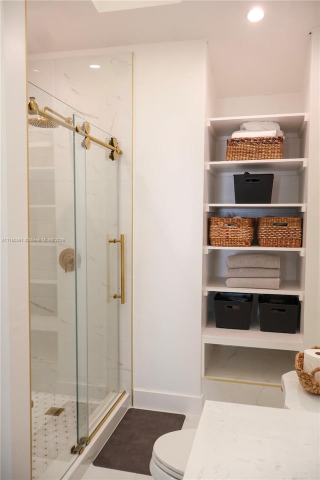 full bath featuring toilet, a stall shower, baseboards, and recessed lighting