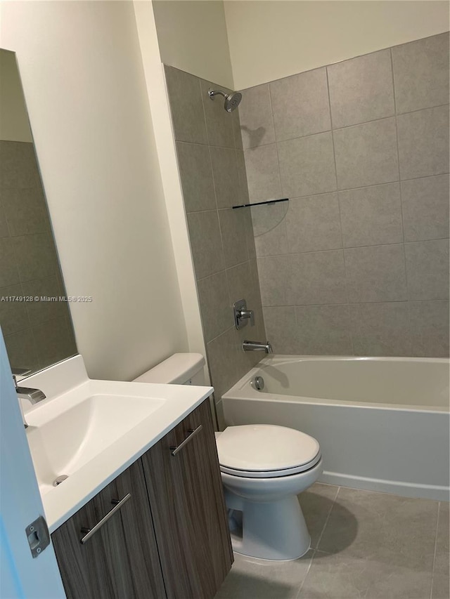 bathroom featuring washtub / shower combination, vanity, toilet, and tile patterned floors