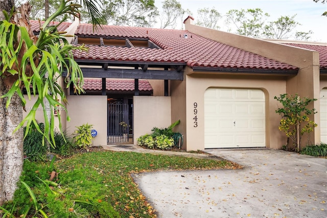 9943 Costa Del Sol Blvd Unit B-108A, Doral, FL 33178 - view of front of home featuring an attached garage, stucco siding, concrete driveway, and a tile roof
