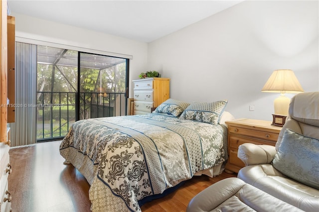 bedroom featuring access to exterior and wood finished floors