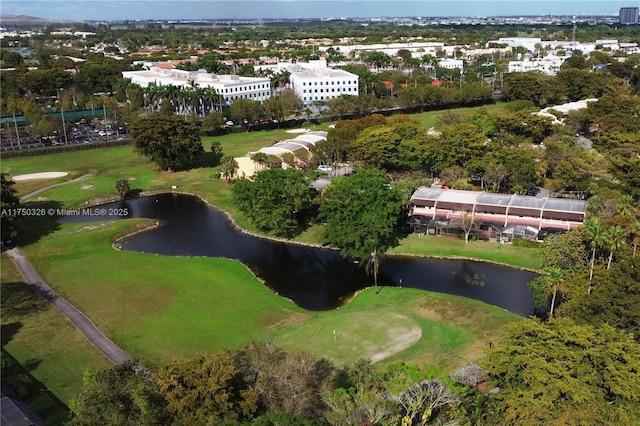 birds eye view of property with golf course view and a water view